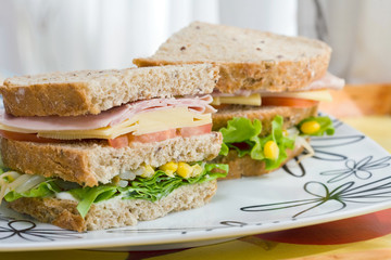 submarine sandwich with whole grain bread on wood platter