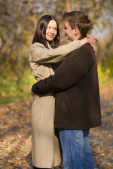 Young couple in love meeting in the autumn park