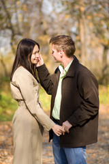 Young couple in love meeting in the autumn park