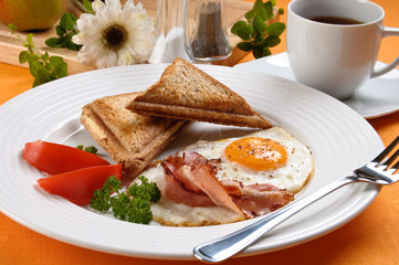Breakfast - toasts, egg, bacon and vegetables