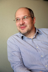 Portrait of the smiling man in glasses