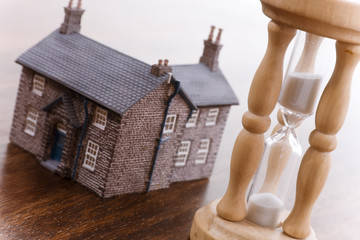 Real estate concept time running out focus on hourglass