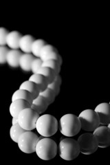 white beads isolated over black