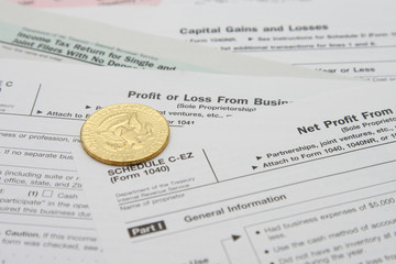 Flip a gold coin for profit or loss for tax sheets