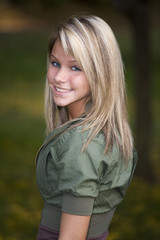 A beautiful blond teenage girl in the park