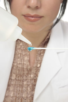 A forensic investigator tests a cotton tip swab