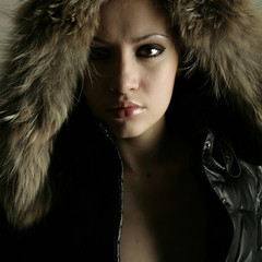 Fashion portrait of young pretty woman with fur