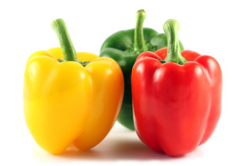 Three multi-coloured pepper isolated on white