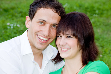 Young, happy and smiling couple in a park.