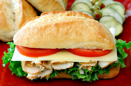 Sub sandwich of turkey, lettuce, cheese and tomato