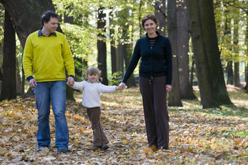 Happy family in autumn park