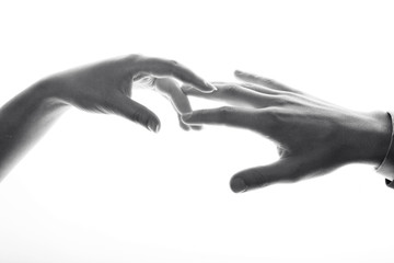 A black and white image of hands. Man and woman.