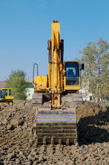 Working  with excavator on yellow  ground