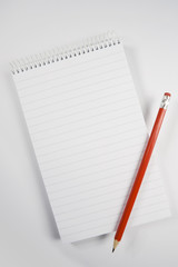 A blank notepad with a red pencil