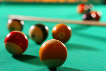Billiard balls on green broadcloth of the billiard table
