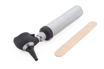 A medical otoscope and a wooden tongue depressor