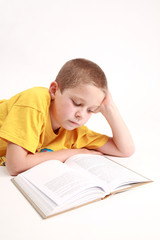 Young boy is reading the book - on white background