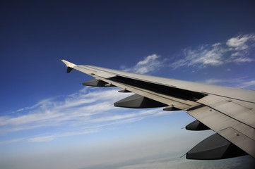 Obraz premium Airplane Flying above the Clouds