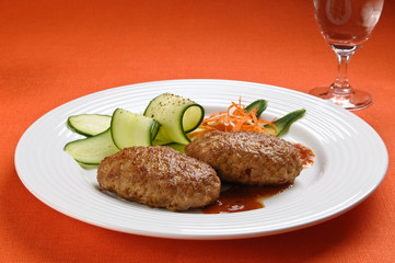 Fried steaks with vegetable salad
