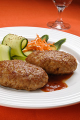 Fried steaks with vegetable salad