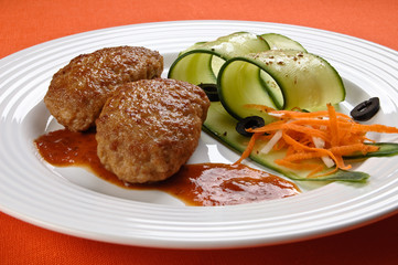 Fried steaks with vegetable salad