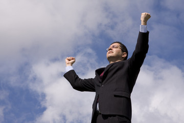 businessman success with his arms outstretched to the sky