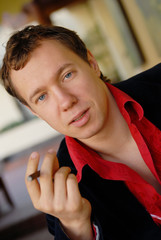 portrait of young man smoking a cigarette