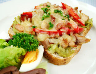 Grilled open chicken sandwich with peppers and cheese