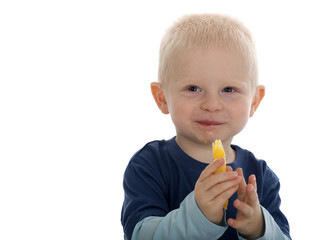 Small boy eating orange