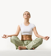 Image of young pretty woman sitting in pose of lotus