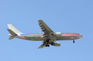 Silver colored passenger jet airplane in flight