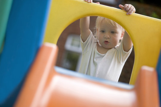 18 month old baby playing in the garden