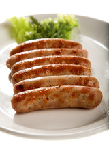 grilled sausage with lettuce isolated on white