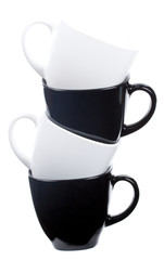 close-up a tower from four coffee cups, isolated on white