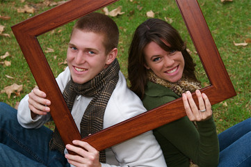 Young couple in an autumn forest picnic area