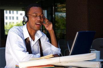 Young Businessman works on a computer outdoors