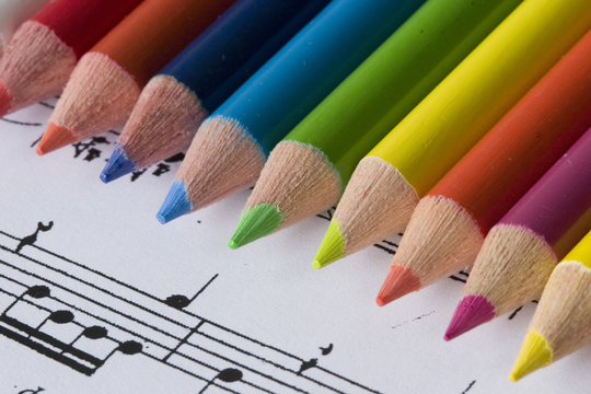 color pencils and sheet music