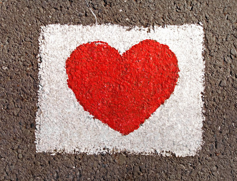 Red heart painted on the road