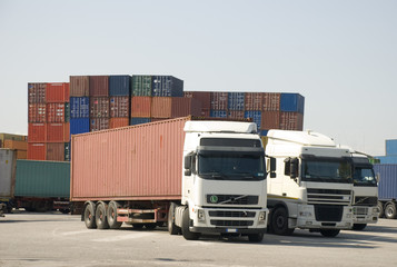Trucks and freight containers in a logistic center