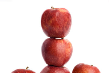 Five balanced red  apple  on a white background