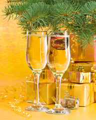 Decoration with an  firtree branch, gift boxes and champagne
