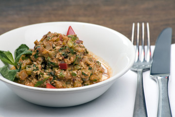 A bowl of fried Aubergine and pepper stew