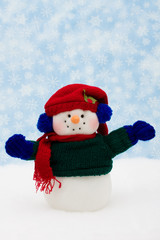 Snowman on snow with snowflake background, merry Christmas