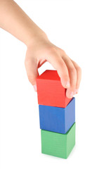 Children's hand and toy cubes