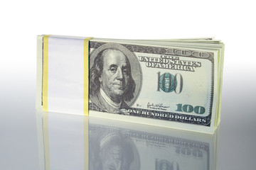 Bundle of dollar's bank notes standing on gray background
