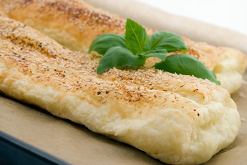 Salty ham strudel with sesame on the plate