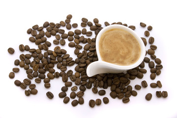 Cup of espresso and coffee beans isolated on white