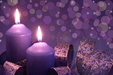 two candle on lilac background