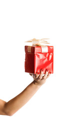 woman is holding a red christmas gift