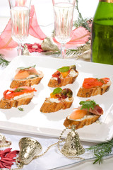 Holiday table of canapes-sandwiches with champagne